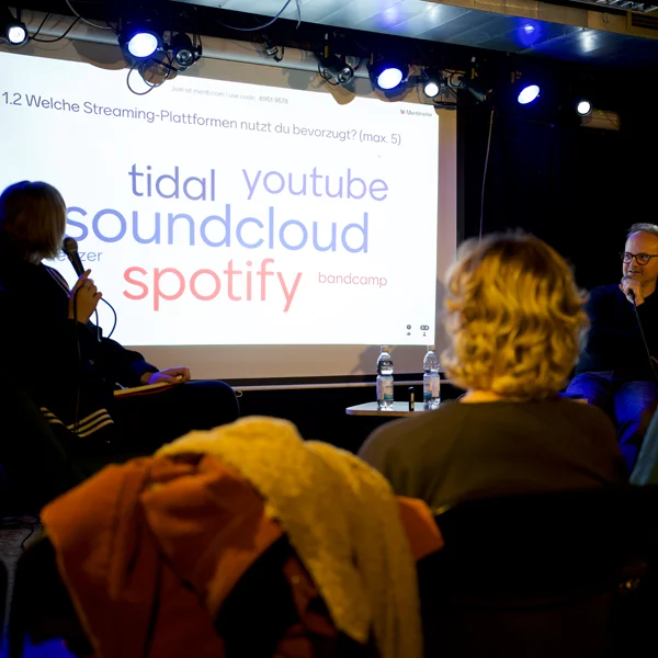 people looking on a big screen